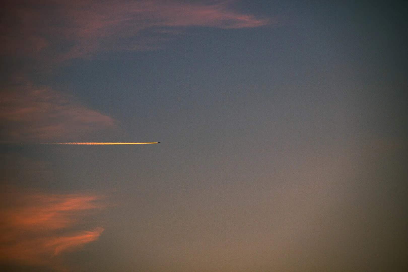 A narrow abstract streak of warm sunset cloud