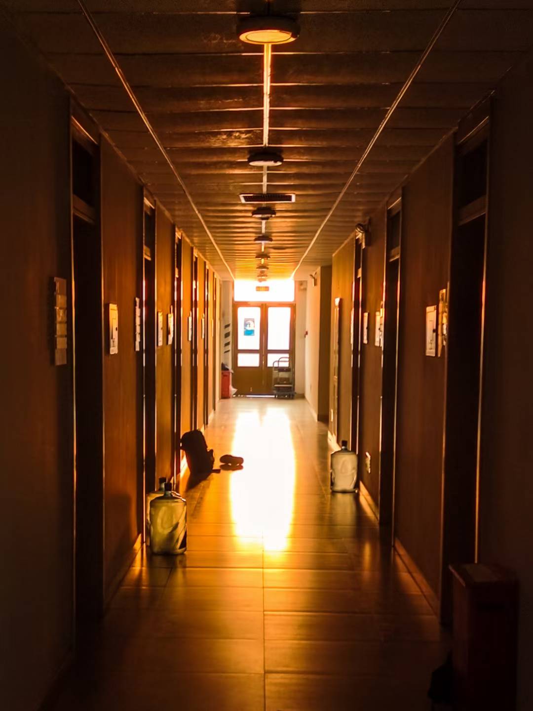 A long corridor ending in warm afternoon light