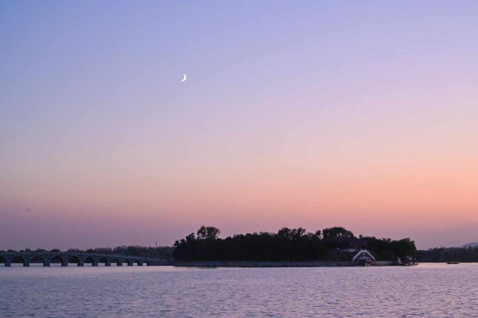 A quiet crescent shoreline in pastel light