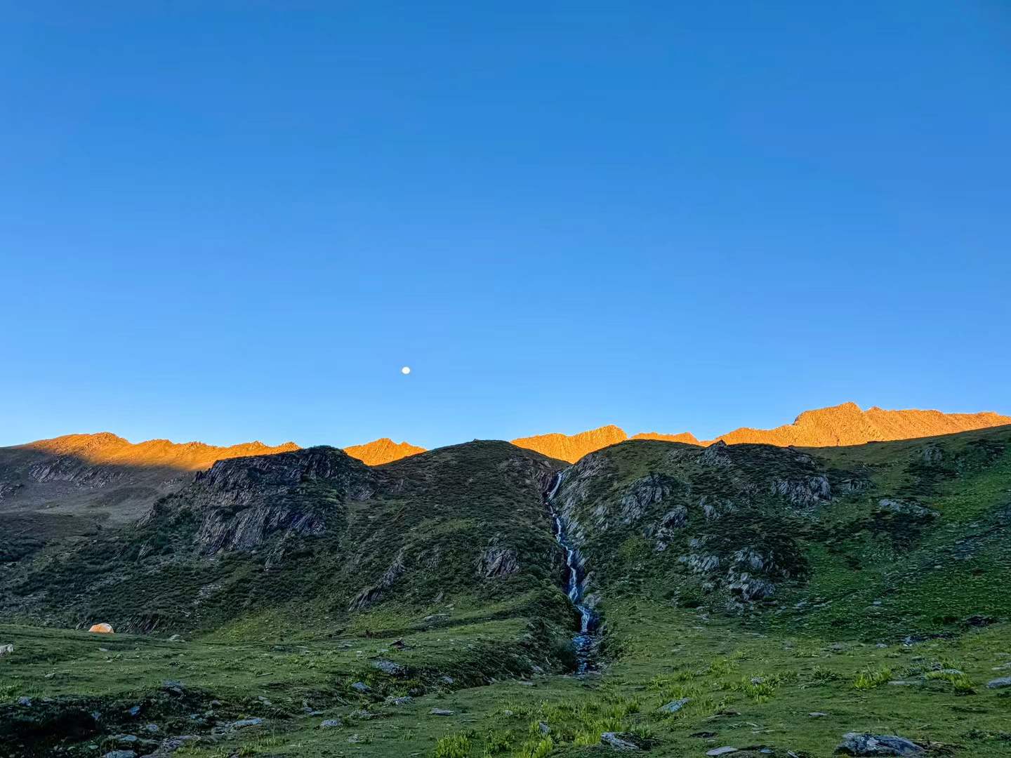 Mountain ridges emerging in cool blue dawn light